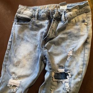 Light washed Jeans. Rips and patches on them.